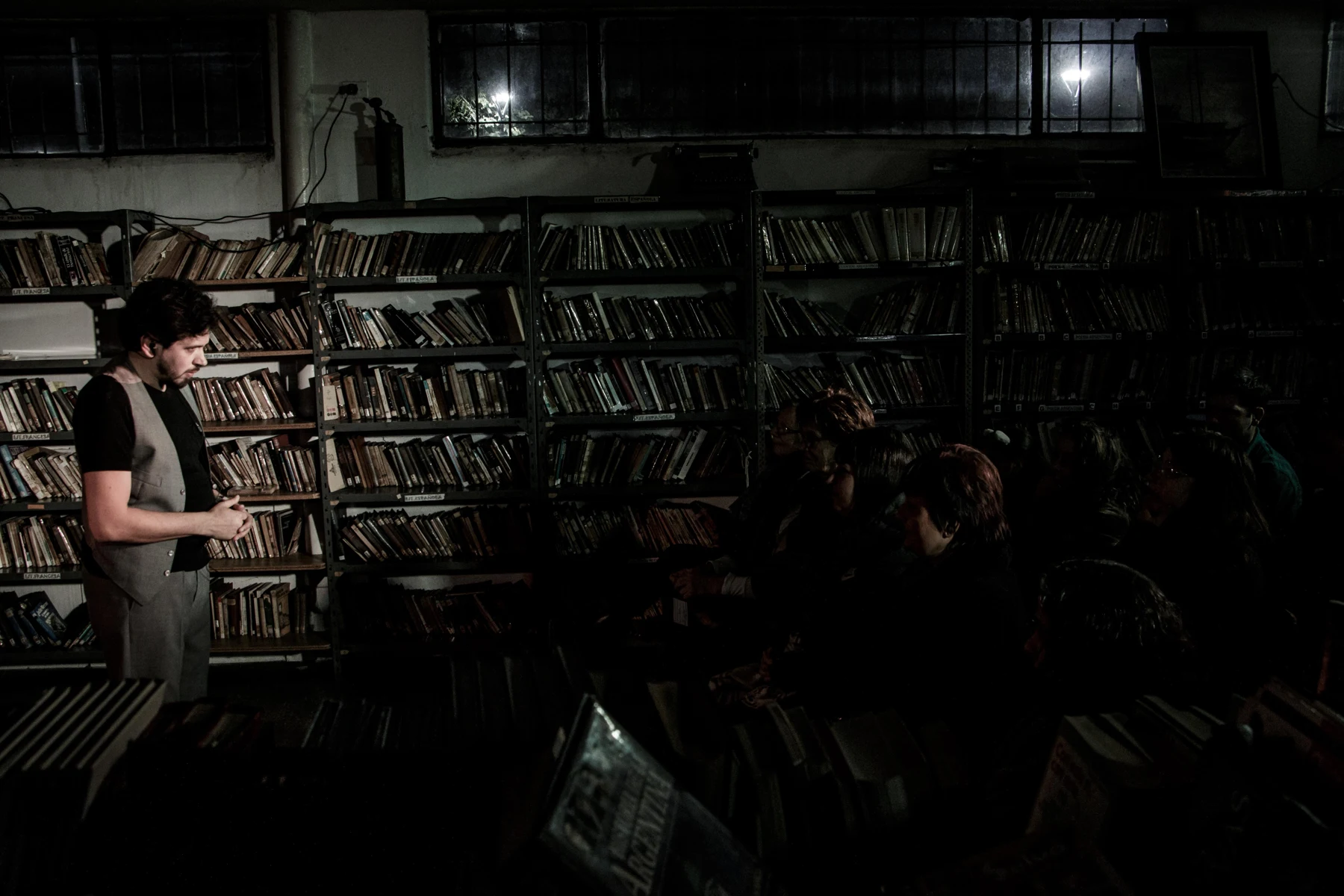 Actor y espectadores próximos, rodeados de libros